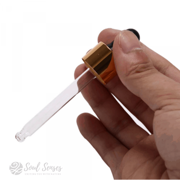Essential Oil Cosmetic Pipette Dropper with Gold Top and Silicone Bulb in hand